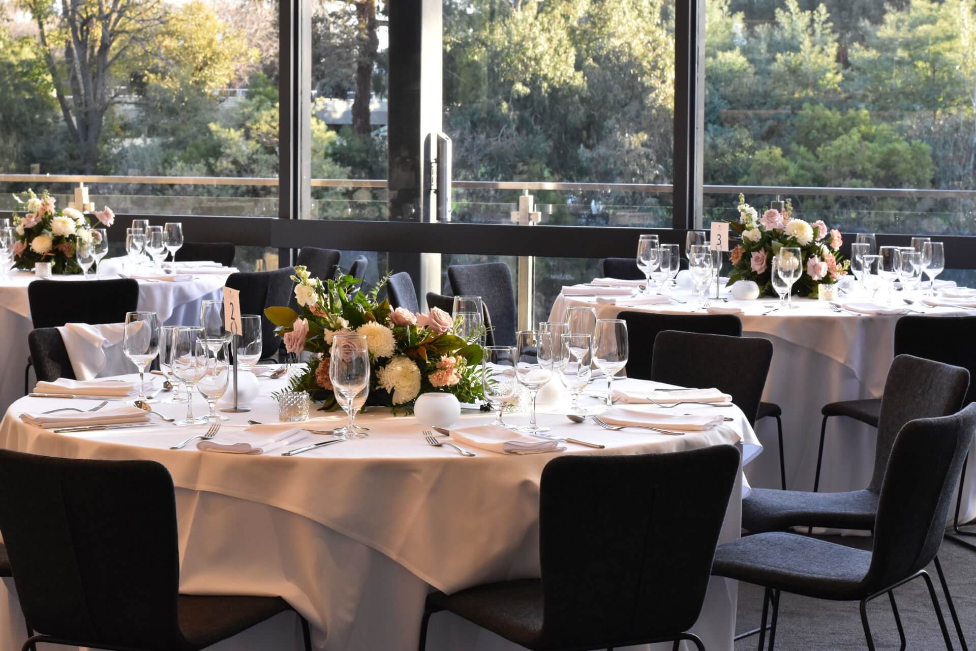 A beautifully decorated wedding venue with tables and chairs arranged for a special celebration.