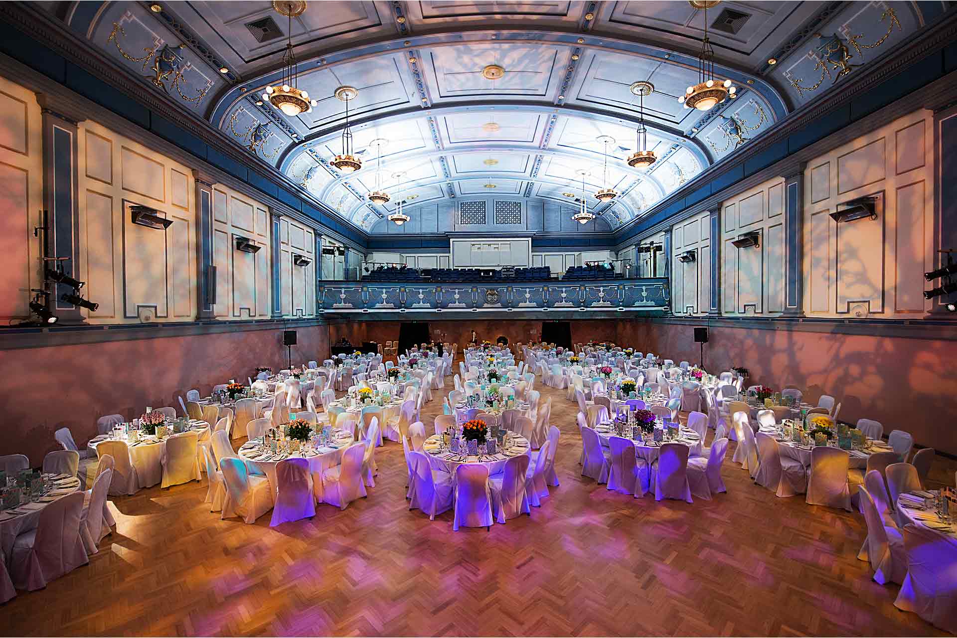 A beautifully decorated wedding venue at Malvern Town Hall with tables and chairs set up for the celebration.