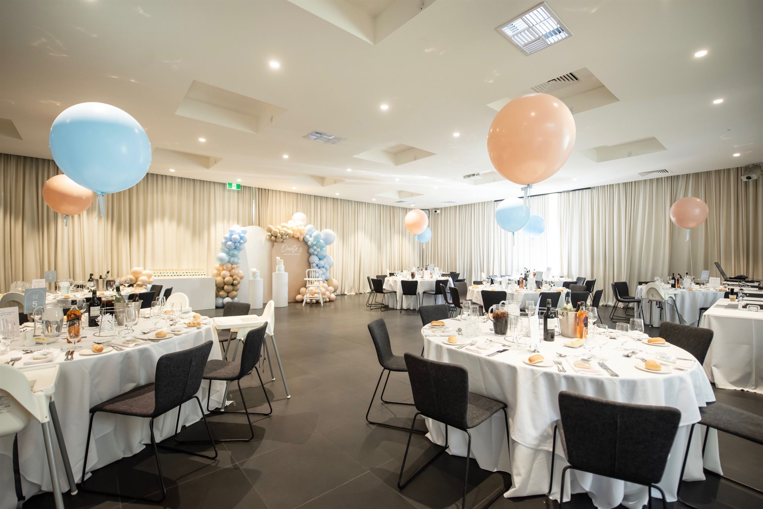 Banquet room with decorated tables and chairs, adorned with balloons. Perfect for Christening Venues in Melbourne.