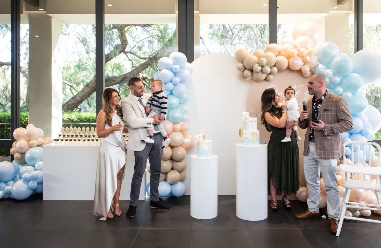 Christening Venues in Melbourne: A festive banquet room with tables and chairs adorned with balloons.