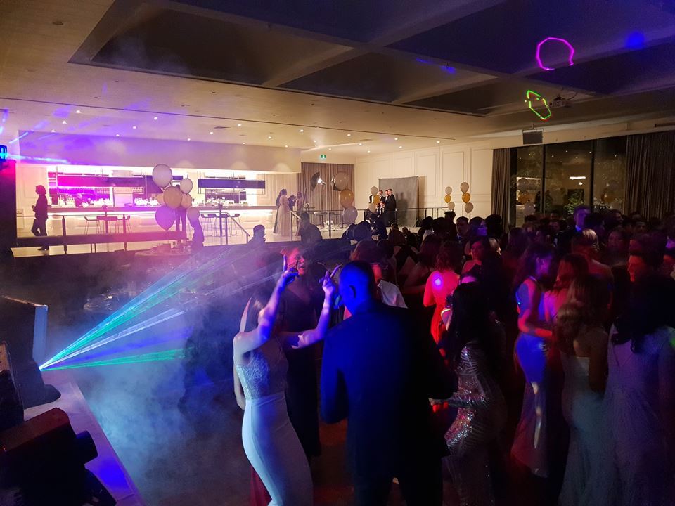 A lively party scene with people dancing and having a great time. School Formal Venues Melbourne.