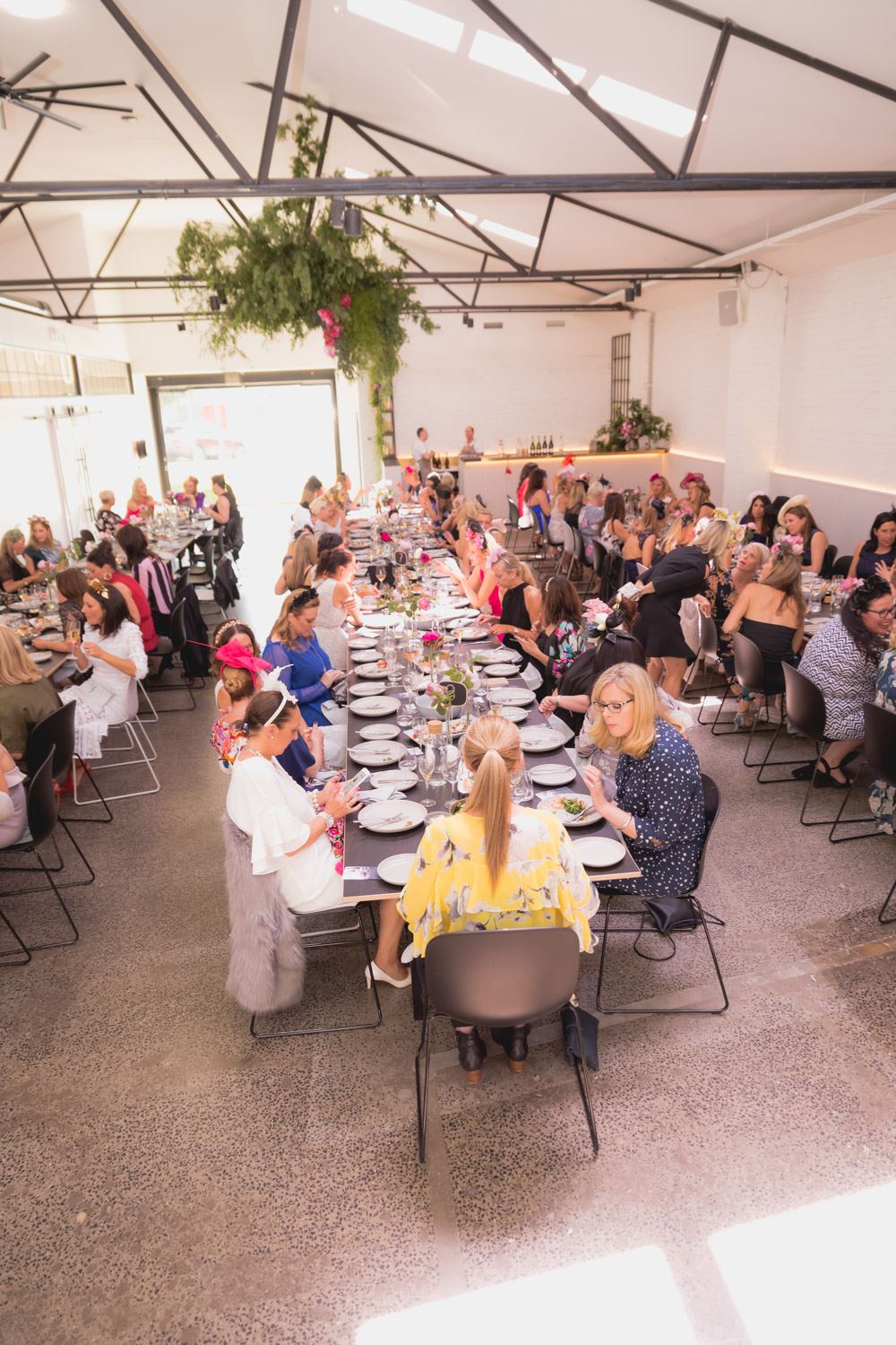 People enjoying a meal at a table in a Christmas party venue in Melbourne.
