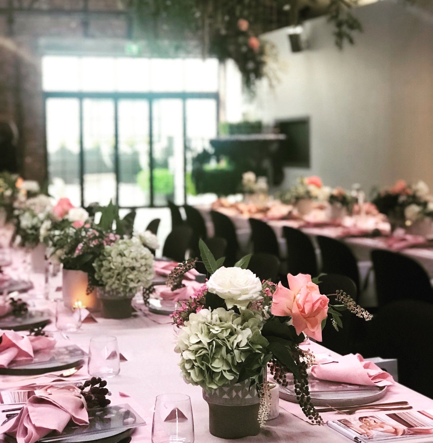 A beautifully decorated wedding reception table with pink and white flowers, perfect for dinner party venues in Melbourne.