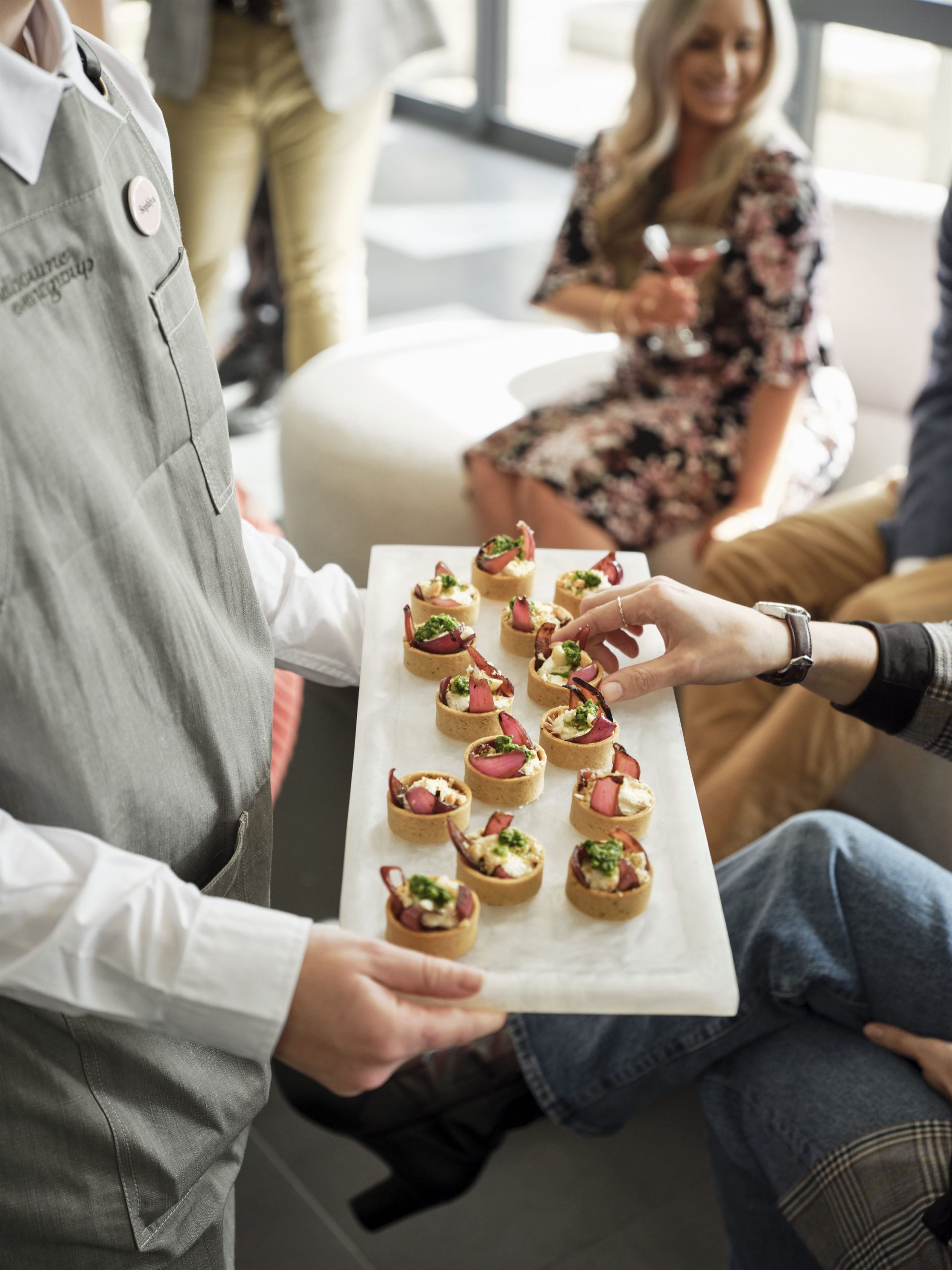 Waiters serve canapes at an engagement party venue in Melbourne.