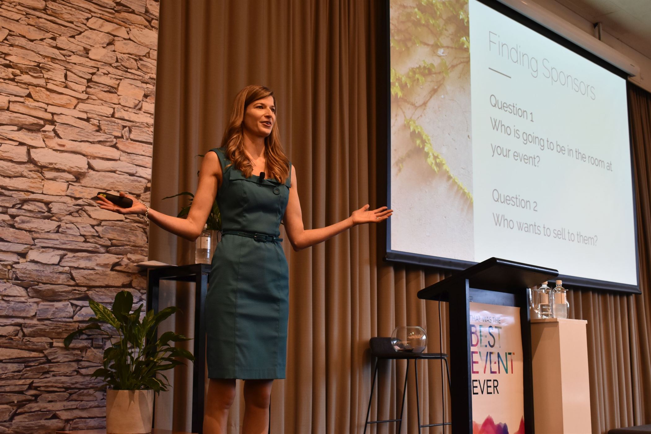 A confident woman presenting at a conference in Melbourne, captivating the audience with her knowledge and expertise.