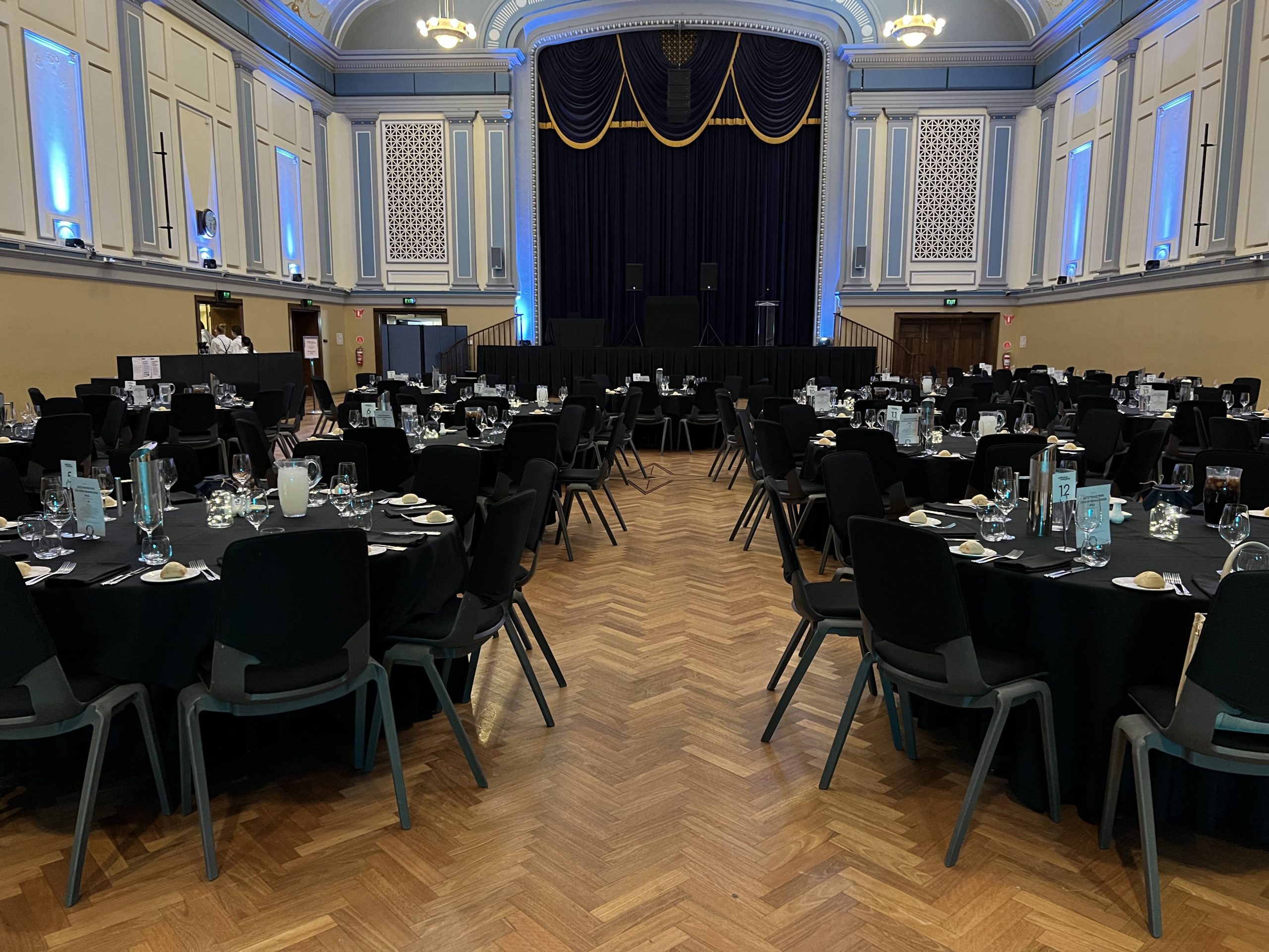 A beautifully decorated wedding venue at Malvern Town Hall with tables and chairs arranged for the celebration.